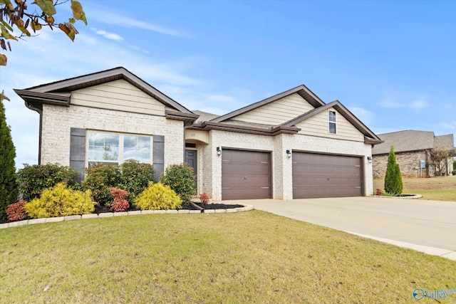 view of front of home featuring a front yard and a garage