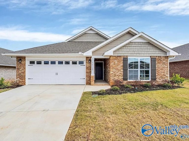 view of front of home featuring a front lawn and a garage