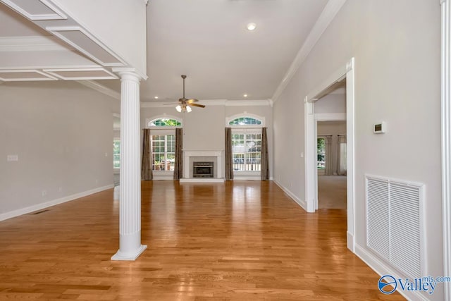 unfurnished living room featuring crown molding, light hardwood / wood-style flooring, decorative columns, and ceiling fan