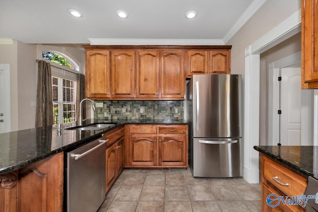 kitchen featuring tasteful backsplash, sink, dark stone countertops, appliances with stainless steel finishes, and light tile patterned floors