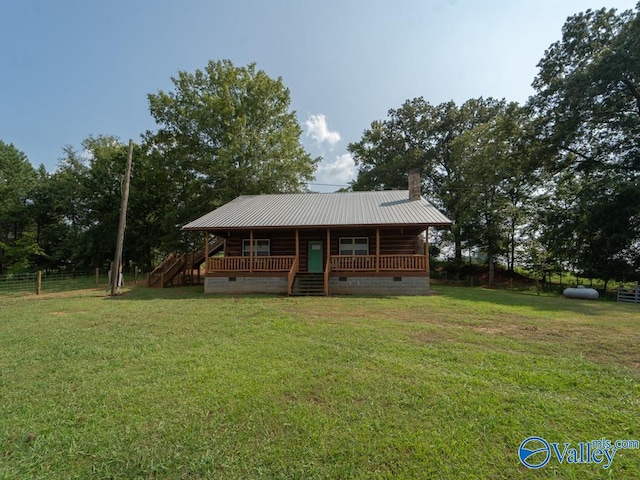 log cabin with covered porch and a front lawn