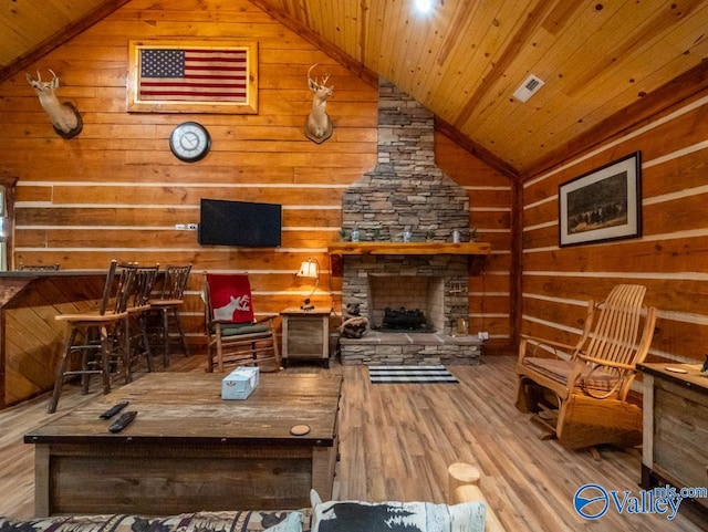 living room featuring a fireplace, vaulted ceiling, light hardwood / wood-style floors, and wood ceiling