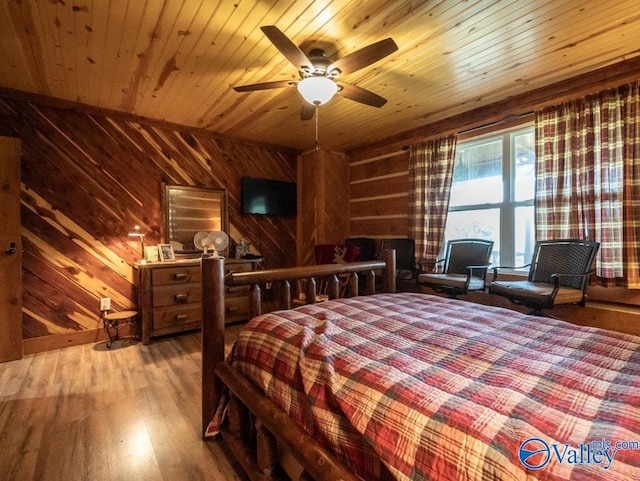 bedroom with wood walls, ceiling fan, hardwood / wood-style flooring, and wooden ceiling