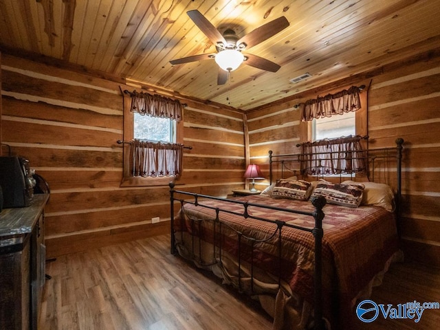 bedroom with ceiling fan, multiple windows, hardwood / wood-style floors, and wood ceiling