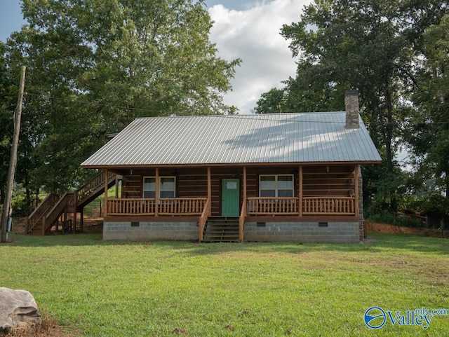 log-style house featuring a porch and a front yard