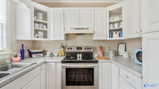 kitchen with stainless steel electric range, light countertops, extractor fan, and white cabinetry