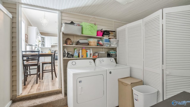 clothes washing area with separate washer and dryer, carpet, and laundry area