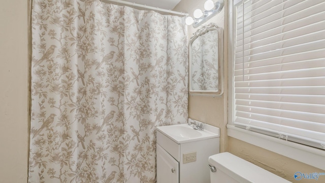 full bathroom with toilet, vanity, and a shower with curtain