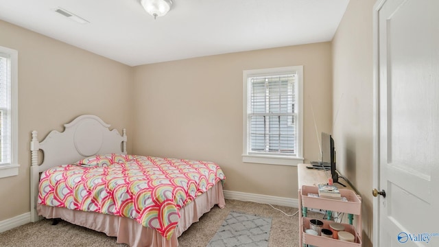 bedroom featuring multiple windows, visible vents, and carpet