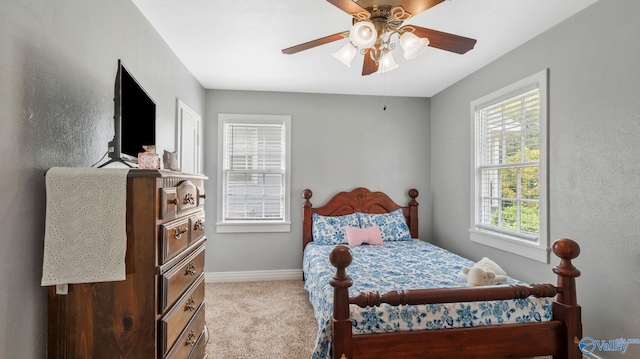bedroom with carpet floors, a ceiling fan, baseboards, and multiple windows