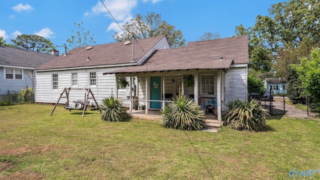 back of house featuring a lawn and a patio