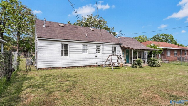 back of property with a fenced backyard, crawl space, and a yard