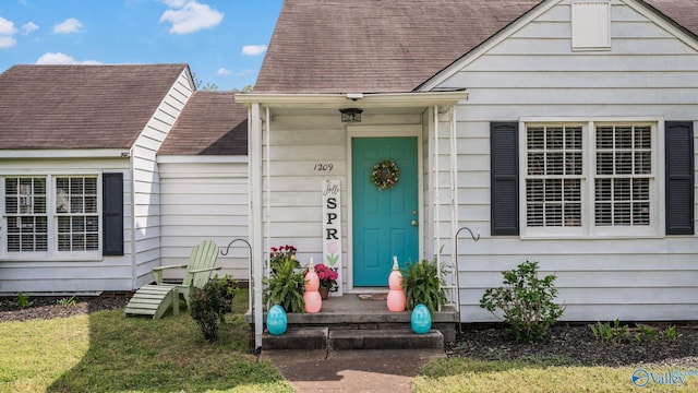 property entrance with roof with shingles