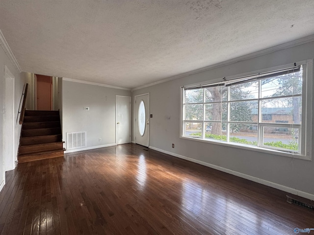 unfurnished living room with dark hardwood / wood-style flooring, ornamental molding, and a textured ceiling