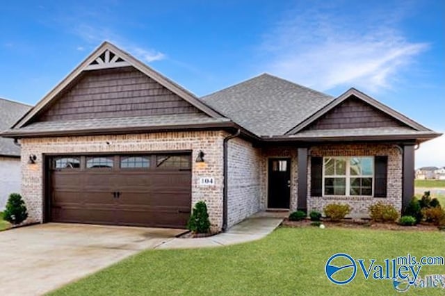 craftsman inspired home with a garage and a front lawn