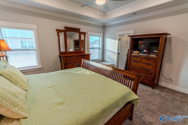 bedroom featuring carpet flooring, ceiling fan, a tray ceiling, and ornamental molding