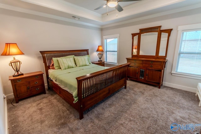 bedroom featuring ceiling fan, a raised ceiling, ornamental molding, and light carpet