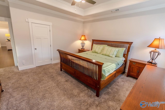 bedroom with ceiling fan, ornamental molding, and light carpet