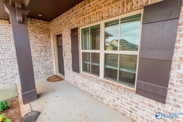 view of exterior entry with a porch