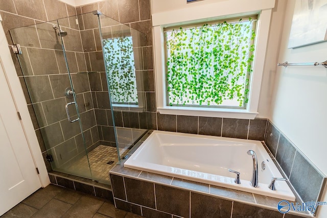 bathroom featuring tile patterned flooring and separate shower and tub