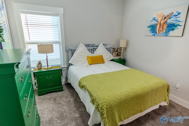 bedroom featuring dark colored carpet