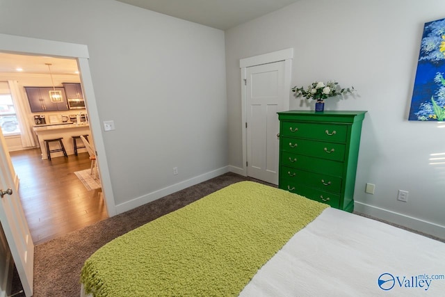 bedroom with dark wood-type flooring