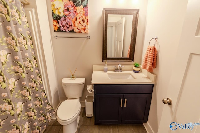 bathroom featuring tile patterned flooring, vanity, and toilet