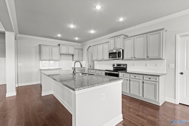 kitchen featuring appliances with stainless steel finishes, tasteful backsplash, stone countertops, and sink