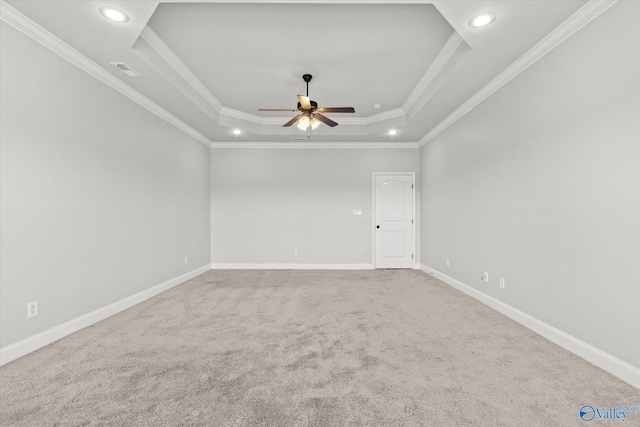 unfurnished room featuring ceiling fan, crown molding, a raised ceiling, and carpet flooring