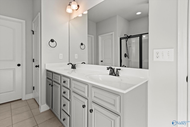 bathroom with tile patterned flooring, an enclosed shower, and vanity