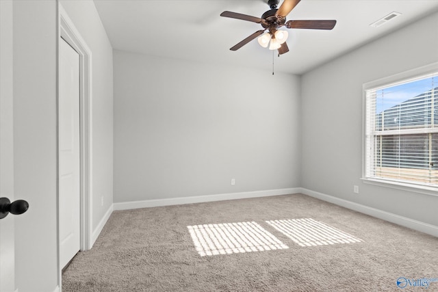 unfurnished room with ceiling fan and light carpet