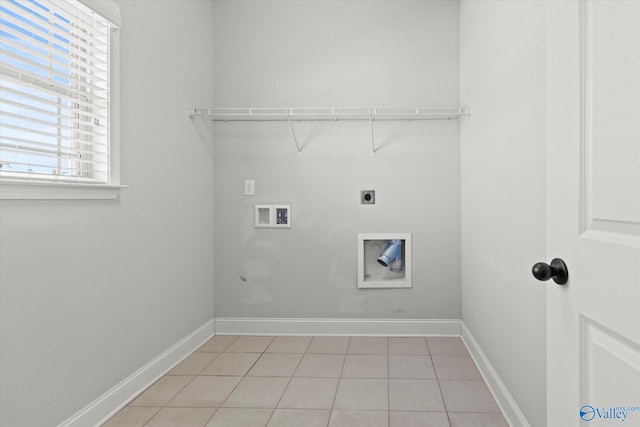 washroom featuring electric dryer hookup, light tile patterned floors, and washer hookup