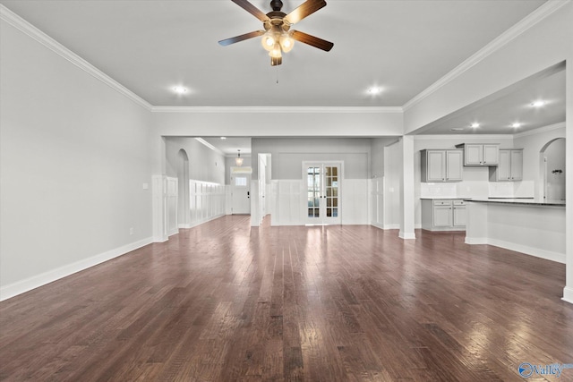 unfurnished living room featuring ceiling fan, crown molding, and dark hardwood / wood-style flooring