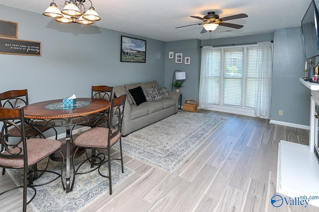 4967 Seven Pine Cir Unit 4967, Huntsville, AL 35816 - dining space featuring ceiling fan, wood finished floors, a textured ceiling, baseboards, and a chandelier