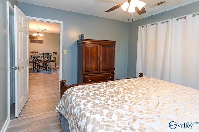 4967 Seven Pine Cir Unit 4967, Huntsville, AL 35816 - bedroom featuring a chandelier, light wood-style flooring, and baseboards