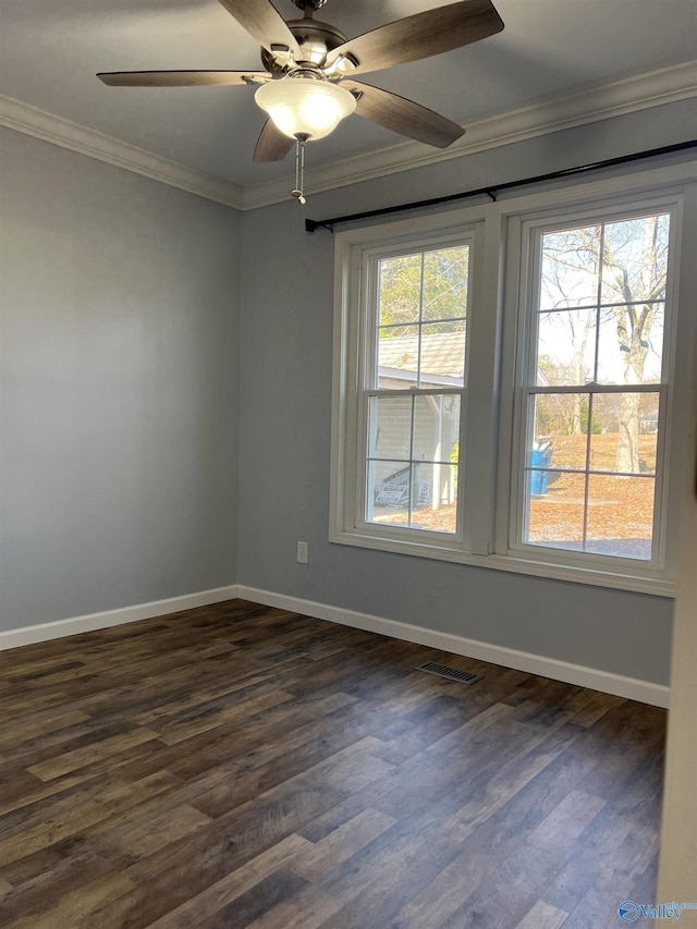 spare room with crown molding, dark wood-type flooring, and ceiling fan