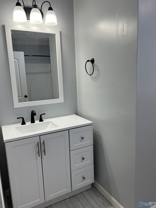 bathroom with vanity and wood-type flooring