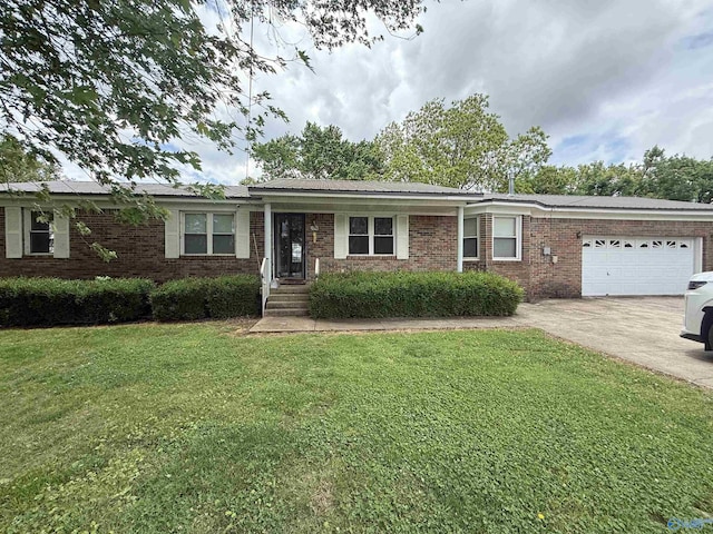 186 Brady Dr, Hazel Green, AL 35750 - ranch-style home featuring an attached garage, a front lawn, concrete driveway, and brick siding