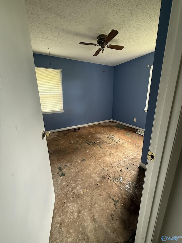 186 Brady Dr, Hazel Green, AL 35750 - spare room featuring a ceiling fan, baseboards, and a textured ceiling