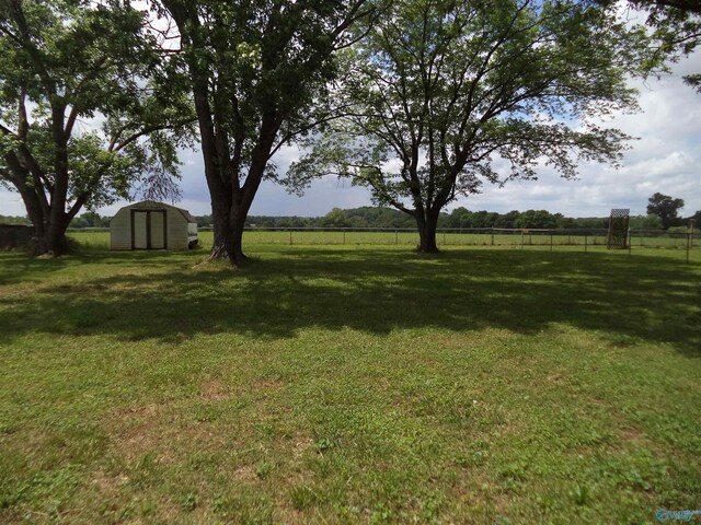 186 Brady Dr, Hazel Green, AL 35750 - view of yard with a storage unit, an outbuilding, and a view of countryside