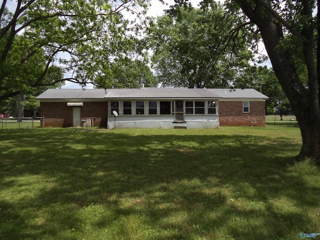 186 Brady Dr, Hazel Green, AL 35750 - rear view of property featuring metal roof and brick siding