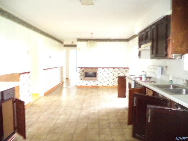 186 Brady Dr, Hazel Green, AL 35750 - kitchen with under cabinet range hood, light countertops, white electric range, a sink, and light flooring