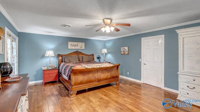 bedroom with ceiling fan, light hardwood / wood-style flooring, ornamental molding, and a textured ceiling