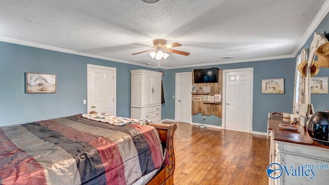 bedroom featuring crown molding, hardwood / wood-style floors, ceiling fan, and a textured ceiling