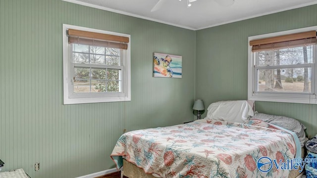 bedroom with ornamental molding and ceiling fan