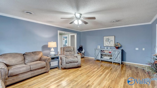 living room featuring crown molding, ceiling fan, light hardwood / wood-style flooring, and a textured ceiling