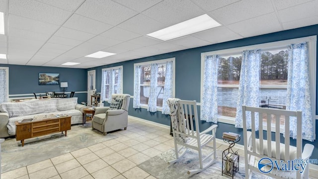 tiled living room with a drop ceiling