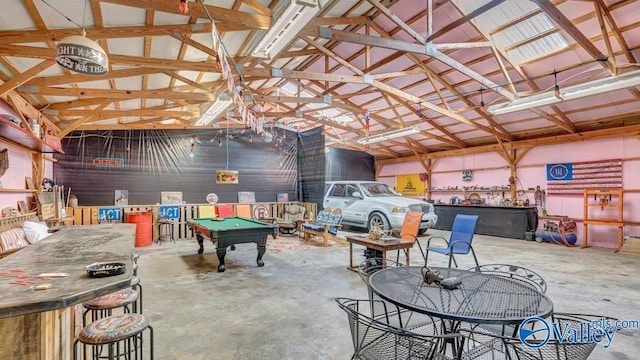 rec room featuring pool table, concrete flooring, and vaulted ceiling