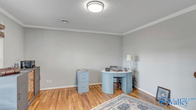 home office with ornamental molding, wood-type flooring, and a textured ceiling