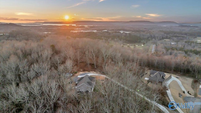 aerial view at dusk featuring a mountain view